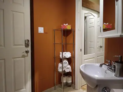 a bathroom with a towel rack next to a sink at Vieux-Old Farnham Appart-Condotel in Farnham