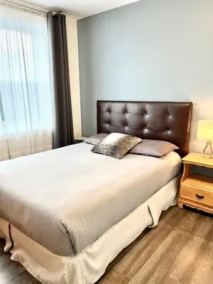 a bedroom with a large bed and a window at Sutton - Condo Au Coeur du Village in Sutton