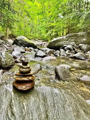 a pile of rocks sitting on top of a river at Sutton - Condo Au Coeur du Village in Sutton