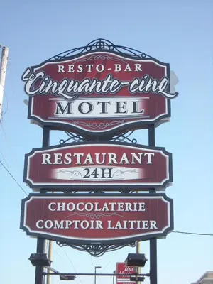 a sign for a restaurant on a pole at Complexe Hotelier Le 55 in Bécancour