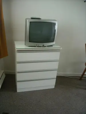 a tv sitting on top of a dresser with a tv at Motel le Verseau in Sorel