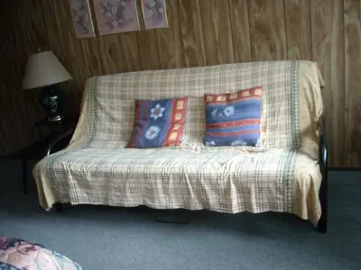 a couch with pillows on it in a room at Motel le Verseau in Sorel