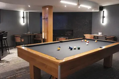 a pool table with balls on it in a room at Hôtel Castel in Granby