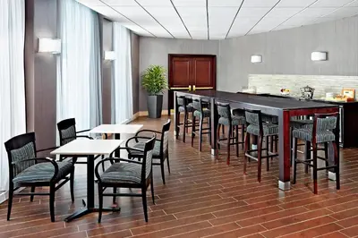 a bar with chairs and tables in a room at Sheraton Montreal Airport Hotel in Dorval
