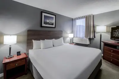 a hotel room with a large bed and a window at Hotel Faubourg Montreal Centre-Ville Downtown in Montréal