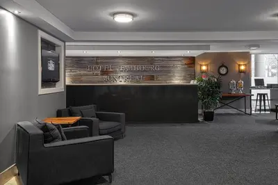 a hotel lobby with two chairs and a reception desk at Hotel Faubourg Montreal Centre-Ville Downtown in Montréal
