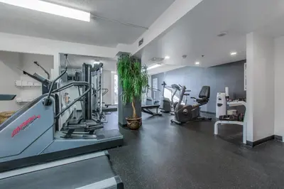 a gym with a treadmill and ellipticals in a room at Hotel Faubourg Montreal Centre-Ville Downtown in Montréal