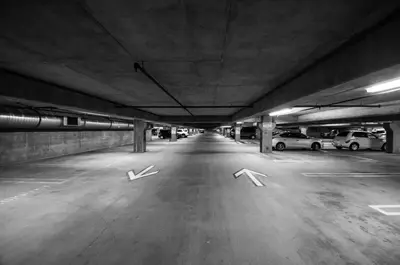 a parking lot with two arrows in a parking garage at Hotel Faubourg Montreal Centre-Ville Downtown in Montréal