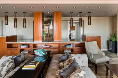 a living room with a couch and a bar at Le Westin Montreal in Montréal