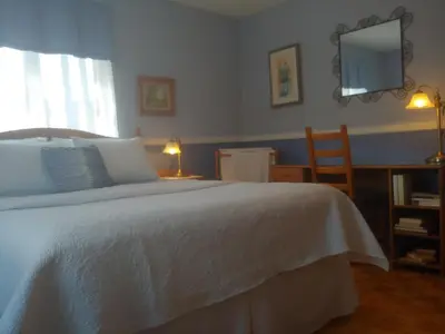 a bedroom with a white bed with a desk and a chair at 3 Bedrooms 3 beds near metro -2 Parking Free in Montréal