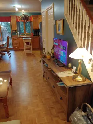 a living room with a table with a television on it at 3 Bedrooms 3 beds near metro -2 Parking Free in Montréal