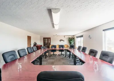 a large conference room with a long table and chairs at Hotel Motel Le Quiet in Lac-Mégantic