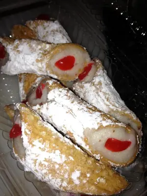 four pieces of food with powdered sugar on them at Repos & Manna Downtown Montréal in Montréal