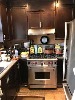 a kitchen with a stainless steel stove and cabinets at Repos & Manna Downtown Montréal in Montréal