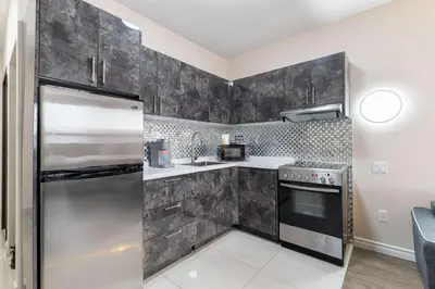 a kitchen with a stainless steel refrigerator at Hotel Montreal Metropolitan, BW Signature Collection in Montréal