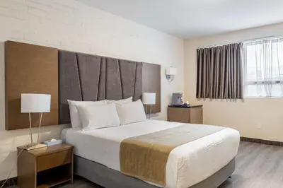 a hotel room with a large bed and a window at Hotel Montreal Metropolitan, BW Signature Collection in Montréal