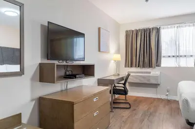 a hotel room with a desk and a tv on the wall at Hotel Montreal Metropolitan, BW Signature Collection in Montréal