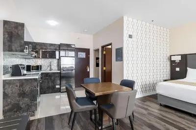 a room with a table and chairs and a bed at Hotel Montreal Metropolitan, BW Signature Collection in Montréal