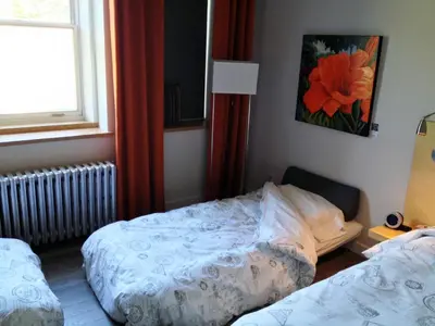 a bedroom with two beds and a window at Suite Marie-Thérèse in Vallée-Jonction