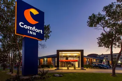 a sign in front of a building with a comfort inn at Comfort Inn South in Brossard