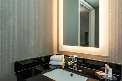 a bathroom with a sink and a mirror at Comfort Inn South in Brossard