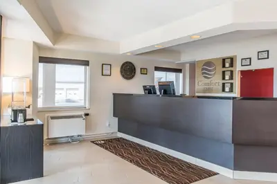 a lobby of a dental office with a reception desk at Comfort Inn South in Brossard