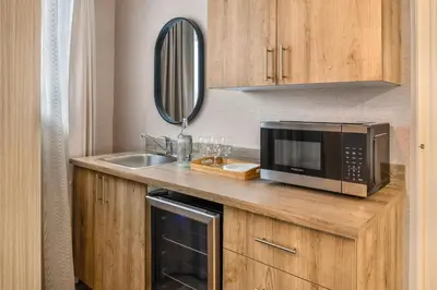 a kitchen with a microwave and a sink at Comfort Inn in Laval