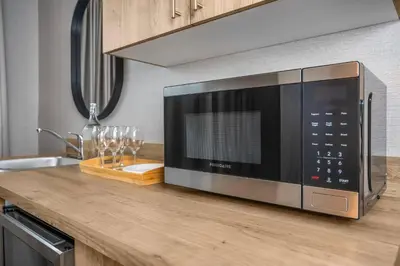 a microwave oven sitting on a counter in a kitchen at Comfort Inn in Laval