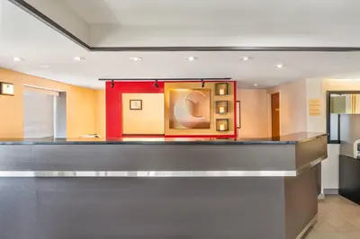 a bar in a room with a red wall at Comfort Inn in Laval