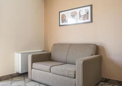 a room with a chair and a picture on the wall at Comfort Inn Sherbrooke in Sherbrooke