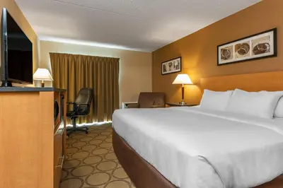 a hotel room with a large bed and a television at Comfort Inn Sherbrooke in Sherbrooke