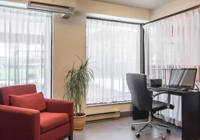 an office with a desk with a computer and a chair at Comfort Inn Sherbrooke in Sherbrooke