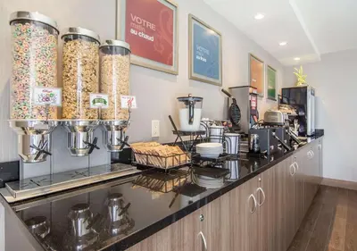 a kitchen with a counter with lots of food at Comfort Inn Sherbrooke in Sherbrooke