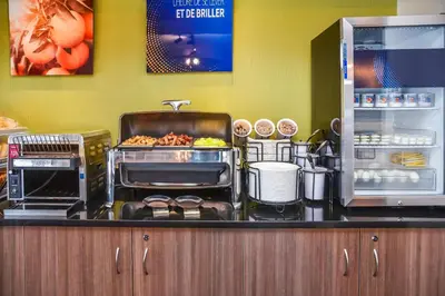 a kitchen with a counter with food on it at Comfort Inn Sherbrooke in Sherbrooke