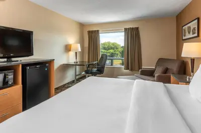 a hotel room with a bed and a television at Comfort Inn Sherbrooke in Sherbrooke