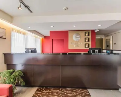 a lobby with a reception desk in a hotel at Comfort Inn in Drummondville