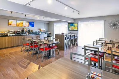 a restaurant with tables and chairs and a counter at Comfort Inn in Drummondville