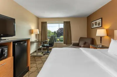 a hotel room with a bed and a television at Comfort Inn in Drummondville