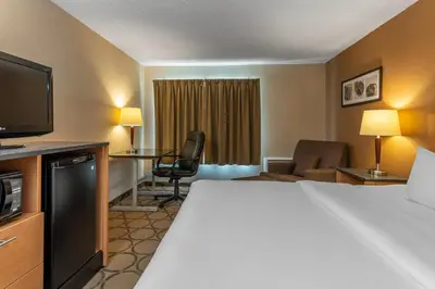 a hotel room with a bed and a television at Comfort Inn in Drummondville