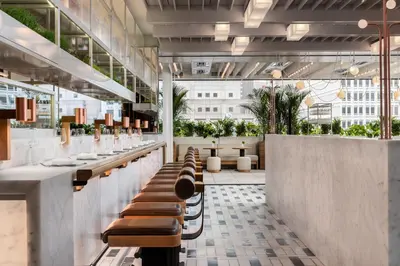 a restaurant with a row of benches and tables at Four Seasons Hotel Montreal in Montréal