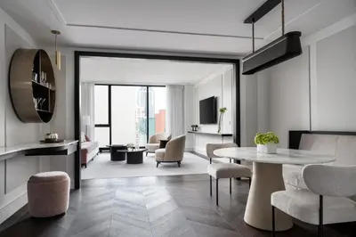 a living room with a table and chairs at Four Seasons Hotel Montreal in Montréal
