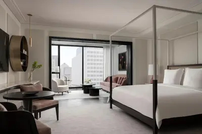 a bedroom with a bed and a living room at Four Seasons Hotel Montreal in Montréal