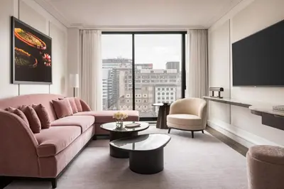a living room with a couch and a tv at Four Seasons Hotel Montreal in Montréal