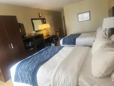 a hotel room with two beds and a television at Comfort Inn in Trois-Rivières