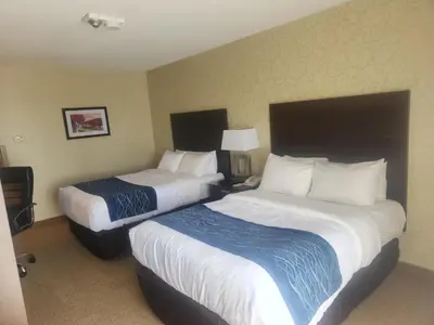 a hotel room with two beds in a room at Comfort Inn in Trois-Rivières