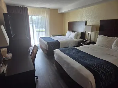 a hotel room with two beds and a window at Comfort Inn in Trois-Rivières