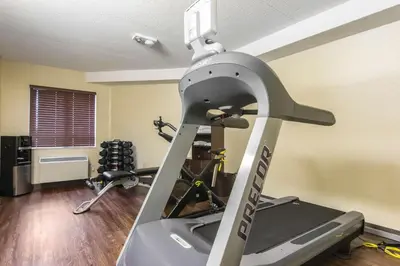 a gym with a treadmill and two exercise bikes at Comfort Inn in Trois-Rivières