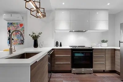 a kitchen with a sink and a stove at LiV MTL Soho in Montréal