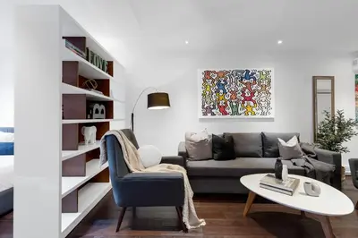 a living room with a couch and a table at LiV MTL Soho in Montréal
