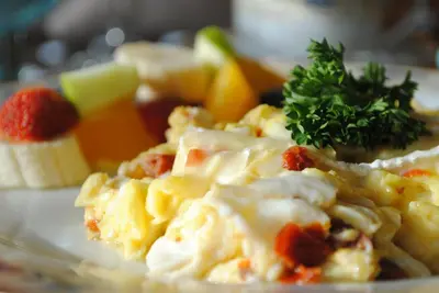 a plate of food with a salad with a garnishment at Auberge Marquis de Montcalm in Sherbrooke